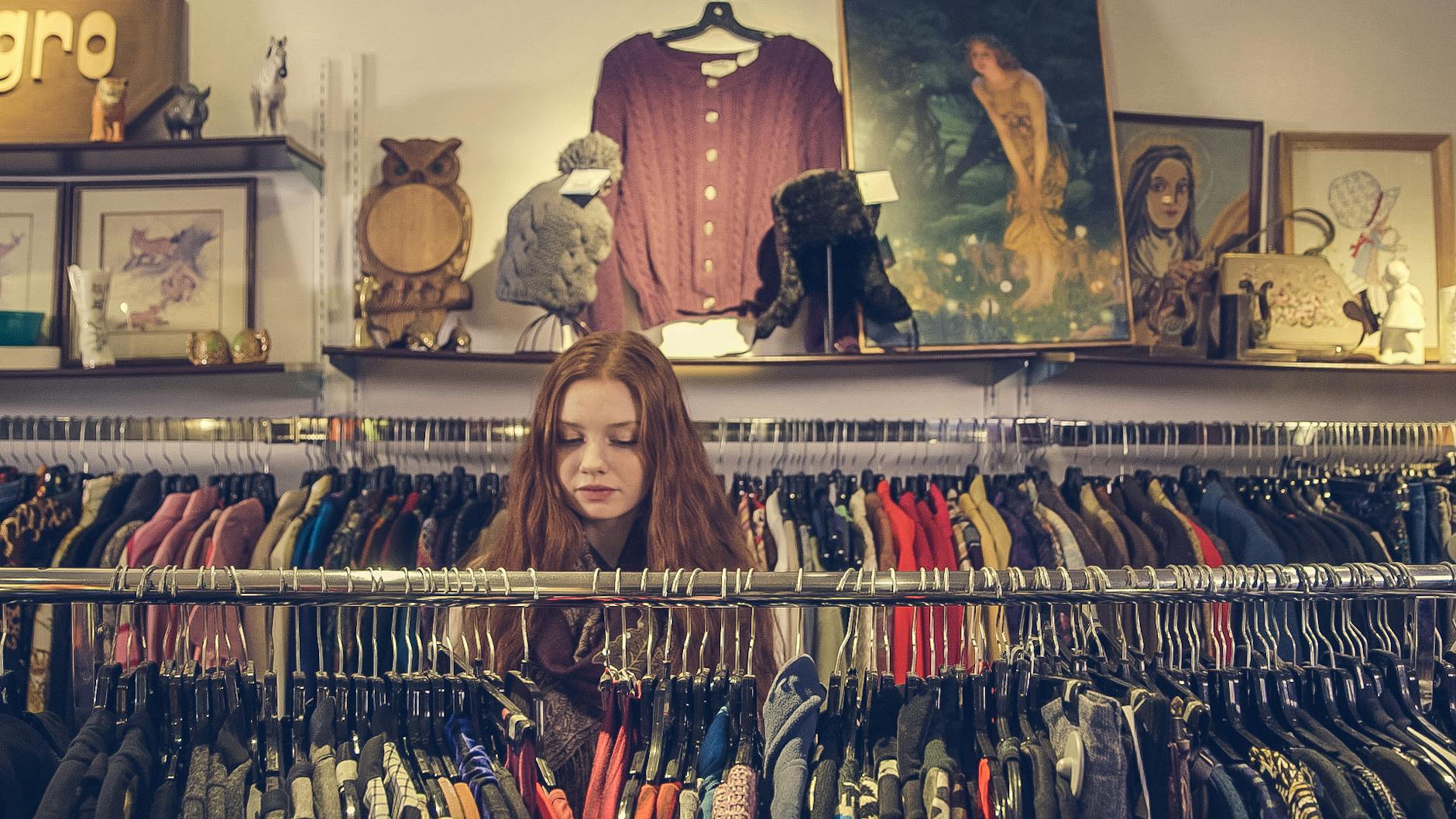 photo of woman near clothes